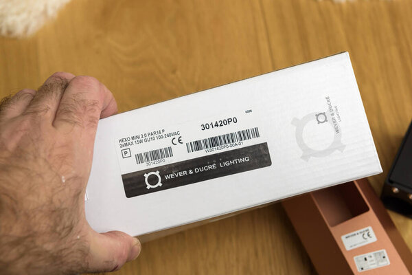 Male hand holding hand on the new Wever and Ducre Lighting package