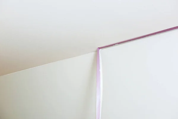 Removal of purple scotch tape from the ceiling — Stok fotoğraf