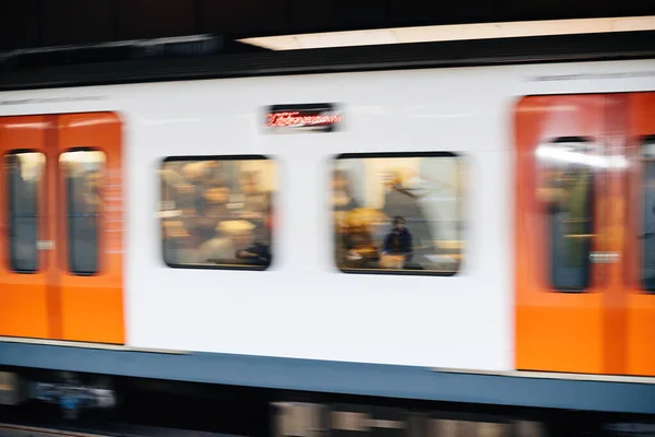 City underground scene with defocused silhouettes of people commuting inside Barcelona metro — Stock Photo, Image