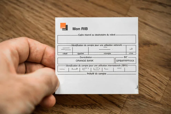 POV mužská ruka držící RIB instrukce Orange Bank — Stock fotografie