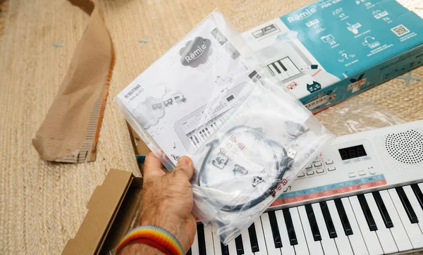 POV male hand unboxing accesories of new Yamaha Remie digital keyboard PSS-E30 — Stock Photo, Image
