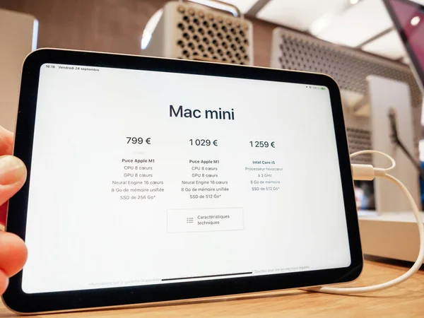 POV male hand holding new Mac Mini Apple Computers new professional tablet showing prices — Stock Photo, Image