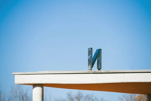 Metallic N letter on the rooftop — Stock Photo, Image