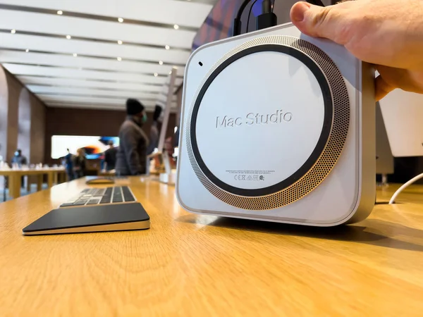 POV male hand hoilding new Mac Studio Macintosh - a small form factor workstation designed, manufactured, and sold by Apple Inc. — Stock Photo, Image