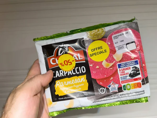 POV forfait main masculin avec Charal Carpaccio Parmesan offre spéciale moins 50 pour cent de réduction - fabriqué à partir de viande française — Photo