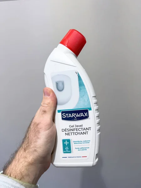 POV male hand holding plastic bottle with Starwax Gel Javel disinfectant nettoyant wc gel cleaner — Stock Photo, Image