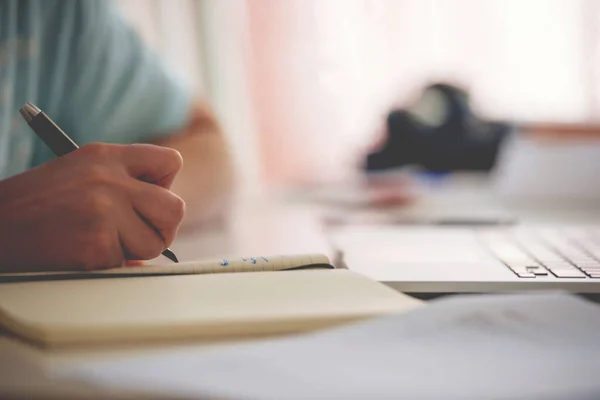 Defocused View Woman Writing Pen Notebook Agenda Her Computer Laptop — Stock Photo, Image