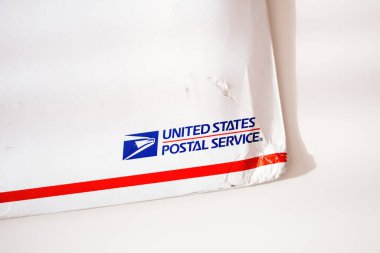 London, United Kingdom - Oct 18, 2014: Close-up view of damaged corner of USPS United States Postal Service Parcel envelope