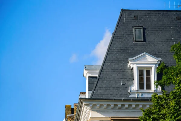 Mansard apartment windows on the rooftop of a French apartment haussmannian building