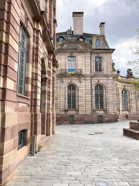 Balcony in city center with Flag of Ukraine on the main building of Palais Rohan in city center Strasbourg support against russian invasion war Ukraine