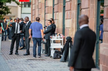 STRASBOURG, FRANCE - SEP, 19 2014: Security guards in front of Apple Store as customers are waiting in line to buy the latest iPhone iPad Apple Watch and notebook MacBook pro