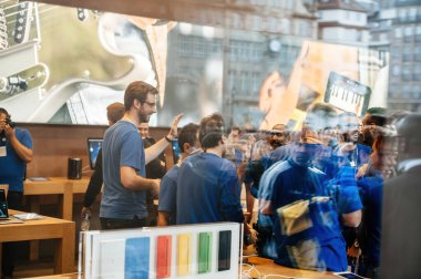 STRASBOURG, FRANCE - SEP, 19 2014: View from the street of Employees give high-fives to customers as they enter the Apple Store Computers to purchase the latest iPhone Pro Se smartphone