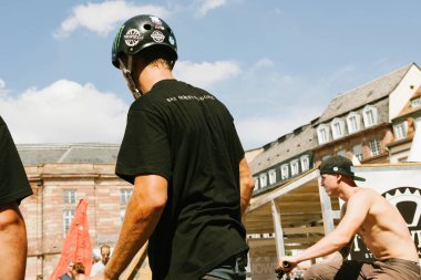 Strasbourg, france - Sep 6, 2014: REar view of male practicing extreme sports in city center - one of it wearing a protection helmet
