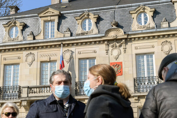 Strasbourg, France - Mar 6, 2022: Defocused unrecognizable peoplein front of Russian Consulate in solidarity with Ukrainians and against the war after Russian invasion