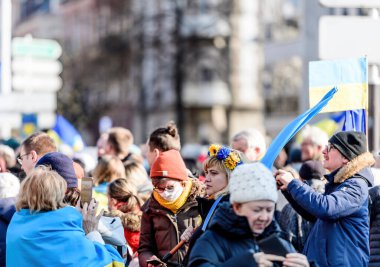 Strasbourg, France - Mar 6, 2022: Side view of hundreds of demonstrators gathered in front of Russian Consulate in solidarity with Ukrainians and against the war after Russian invasion