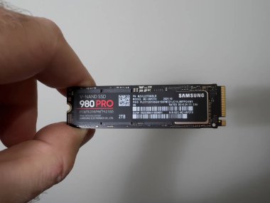 Paris, France - Aug 4, 2022: POV male hand unboxing unpacking new Samsung 980 Pro NVME ss hard disk drive for the personal computer or mac Apple upgrade - white background 2 tb disk