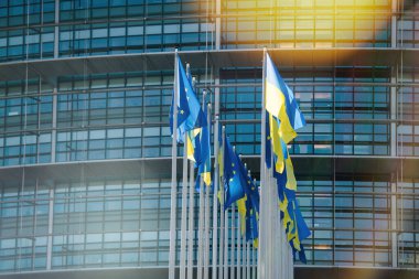 Strasbourg, Fransa - 8 Mart 2022: Ukrayna bayrağı Avrupa Bayrağı 'nın yanında dalgalanıyor ve bütün AB üyeleri parlamento binası önünde bayraklar dikiyorlar. Rusya Ukrayna 'ya saldırısına devam ediyor