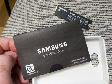 Paris, France - Aug 8, 2022: POV male hand reading after unboxing new Samsung 980 Pro NVME ssd hard disk drive for the personal computer or mac Apple upgrade