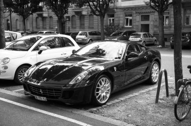 Paris, France - Jun 27, 2015: Monochrome image of black Ferrari car parked in city