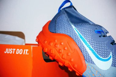 Hilversum, Netherlands - May 5, 2022: Detail of new Nike Wildhorse 7 - men trail running shoes lean on red Just Do it package