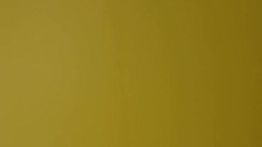 Movie slate or clapperboard hitting. Close up hand holding empty film slate and clapping it. Open and close film slate for video production. film production. color background studio. ready to shoot