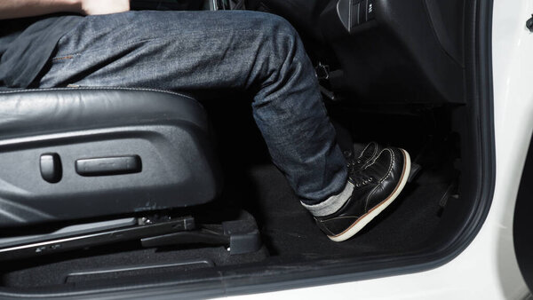Accelerate and Brake. Foot pressing foot pedal of a car to drive ahead. Accelerator and brake pedal in a car. Driver driving the car by pushing accelerator pedals of the car. inside vehicle automobile