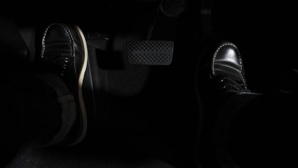 Accelerate and Brake. Foot pressing foot pedal of a car to drive ahead. Accelerator and brake pedal in a car. Driver driving the car by pushing accelerator pedals of the car. inside vehicle automobile