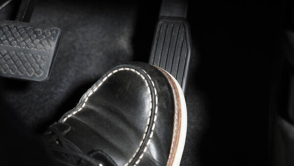 Ускорение и тормоз. Нога нажимает педаль педали автомобиля, чтобы ехать вперед. Ускоритель и тормозная педаль в машине. Водитель управлял машиной, нажимая педали акселератора автомобиля. внутренний автомобиль автомобиля