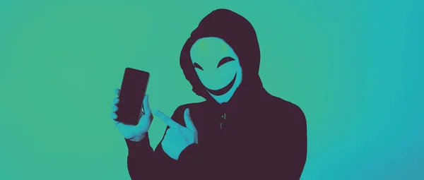Anonimowy Haker Maska Twarzy Smartfonem Ręku Mężczyzna Czarnym Kapturze Trzyma — Zdjęcie stockowe
