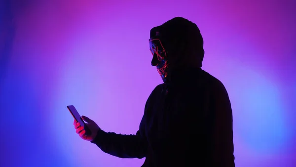 Hacker Anonim Mască Față Smartphone Mână Bărbat Cămașă Neagră Încearcă — Fotografie, imagine de stoc