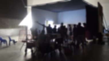 Stüdyoda video yapımcılığında çalışırken görüntüler bulanıklaşır. Video prodüksiyon sahnelerinin arkasında. Yönetmen ve film ekibinin kamera ışıklandırmalı bir filmini çekmek ya da çekmek.