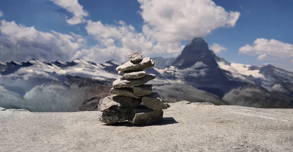 Stack of stones on top of the mountain. Pile of rocks stone and mountains. Balanced stone pyramid or Stacked stone or mountain stones tower. Stones arranged for meditation. Represent spirit of Zen.