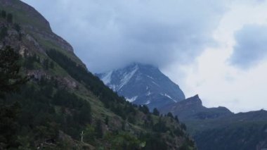 Matterhorn Time lapse 4k video. Beautiful nature of Matterhorn mountain Zermatt Switzerland Alps. Moving cloud moment before rain. View from Zermatt city. Matterhorn peak with clouds cover. Timelapse.