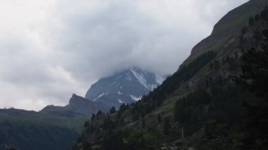 Matterhorn Time lapse 4k video. Beautiful nature of Matterhorn mountain Zermatt Switzerland Alps. Moving cloud moment before rain. View from Zermatt city. Matterhorn peak with clouds cover. Timelapse.