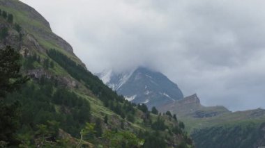 Matterhorn Time lapse 4k video. Beautiful nature of Matterhorn mountain Zermatt Switzerland Alps. Moving cloud moment before rain. View from Zermatt city. Matterhorn peak with clouds cover. Timelapse.