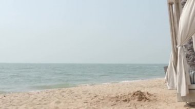 Beach Sand and Sea. Pattaya beach which one of the famous sea locations in Thailand. Represent vacation relaxing. Open country for travelers after Covid 19 pandemic. Sea waves and sand with blue sky.