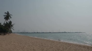 Beach Sand and Sea. Pattaya beach which one of the famous sea locations in Thailand. Represent vacation relaxing. Open country for travelers after Covid 19 pandemic. Sea waves and sand with blue sky.