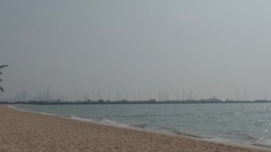 Beach Sand and Sea. Pattaya beach which one of the famous sea locations in Thailand. Represent vacation relaxing. Open country for travelers after Covid 19 pandemic. Sea waves and sand with blue sky.