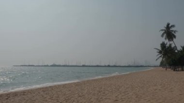 Beach Sand and Sea. Pattaya beach which one of the famous sea locations in Thailand. Represent vacation relaxing. Open country for travelers after Covid 19 pandemic. Sea waves and sand with blue sky.