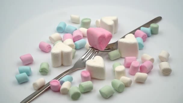 Marshmallows rosa och vitt i form av hjärtan roterar. Video närbild ovanifrån. — Stockvideo
