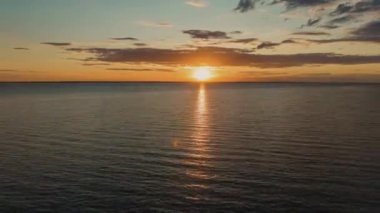 Beautiful timelapse landscape with a sunset over the sea, with lush clouds