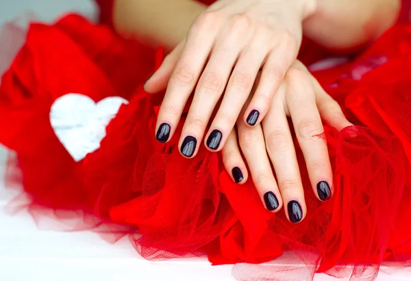 Dark fashion manicure on red — Stock Photo, Image