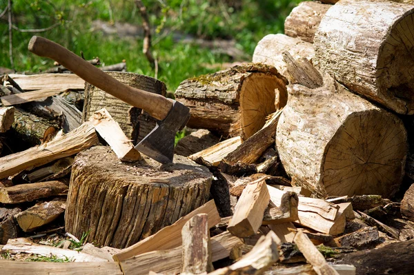 Machado e troncos de madeira — Fotografia de Stock