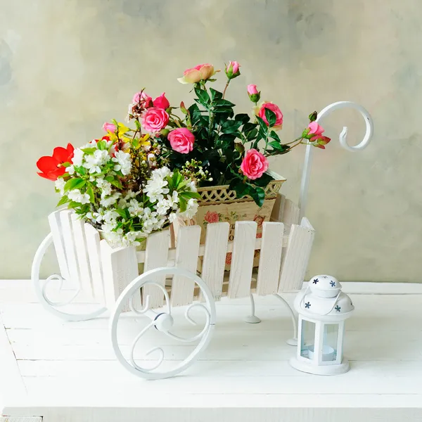 Witte kruiwagen met bloemen — Stockfoto