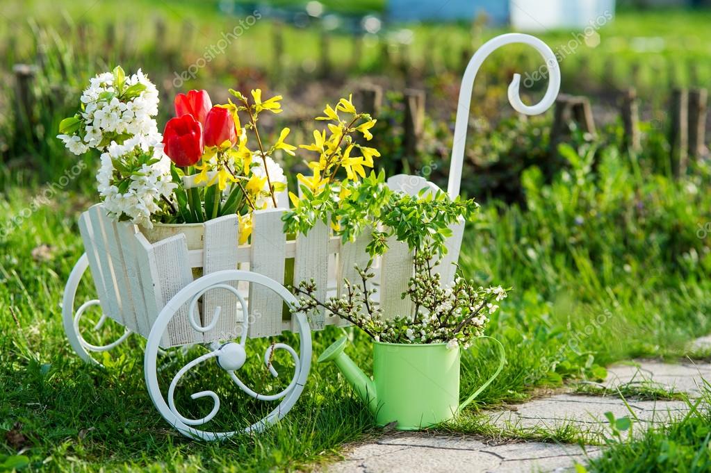 http://st.depositphotos.com/1084113/2513/i/950/depositphotos_25135359-Garden-utensils-and-wheelbarrow-with-flowers.jpg