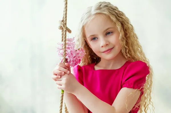 Portrait of an adorable girl with pink flowers — Stock Photo, Image