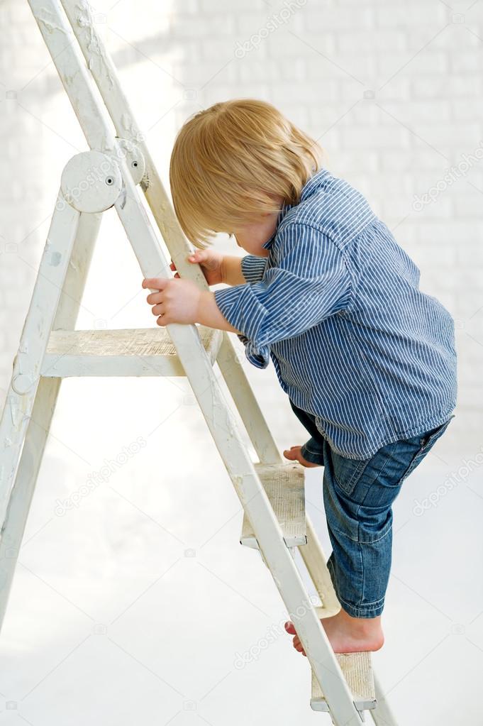 Kid climbing the ladder Stock Photo by ©zoiakostina 25560619
