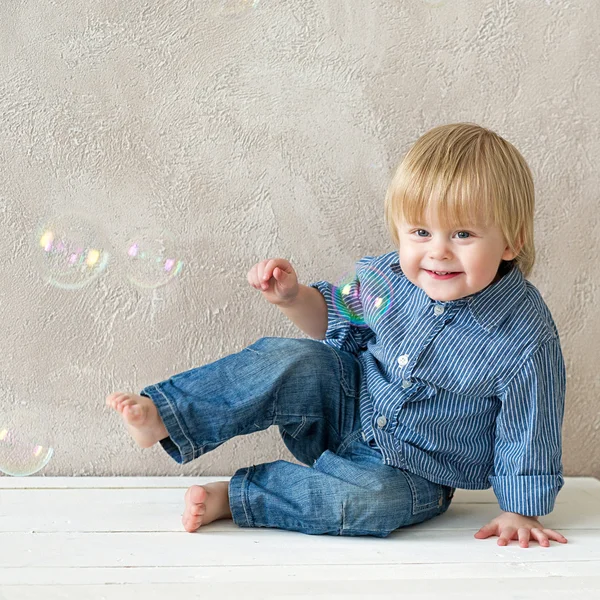 Kid with soap bubbles Stock Picture