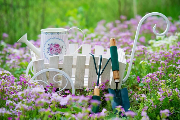 Garden utensils on the flower lawn — Stock Photo, Image