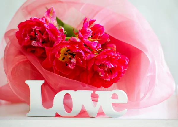 Delicate tulips and love signage — Stock Photo, Image